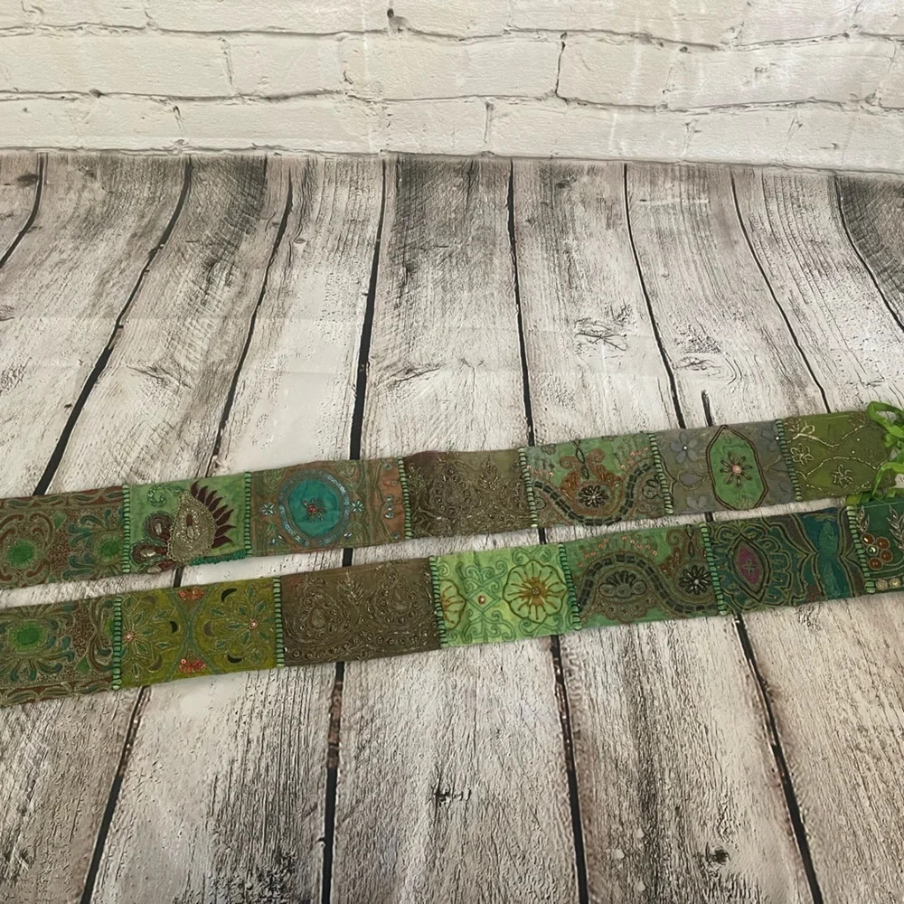Two green ornate curtain tassels